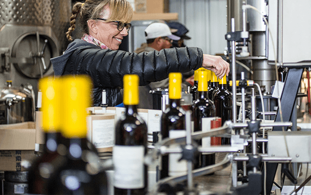 wine bottles being labled