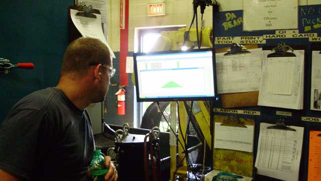 A photo of an operator at United Gear and Assembly using Synergy 2000 SPC Software.